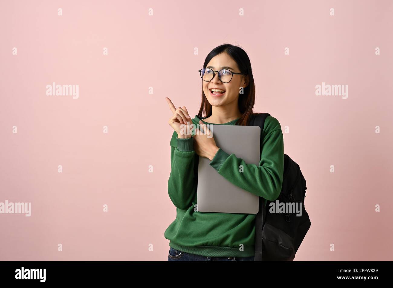 Wise and positive young Asian female college student with her backpack ...