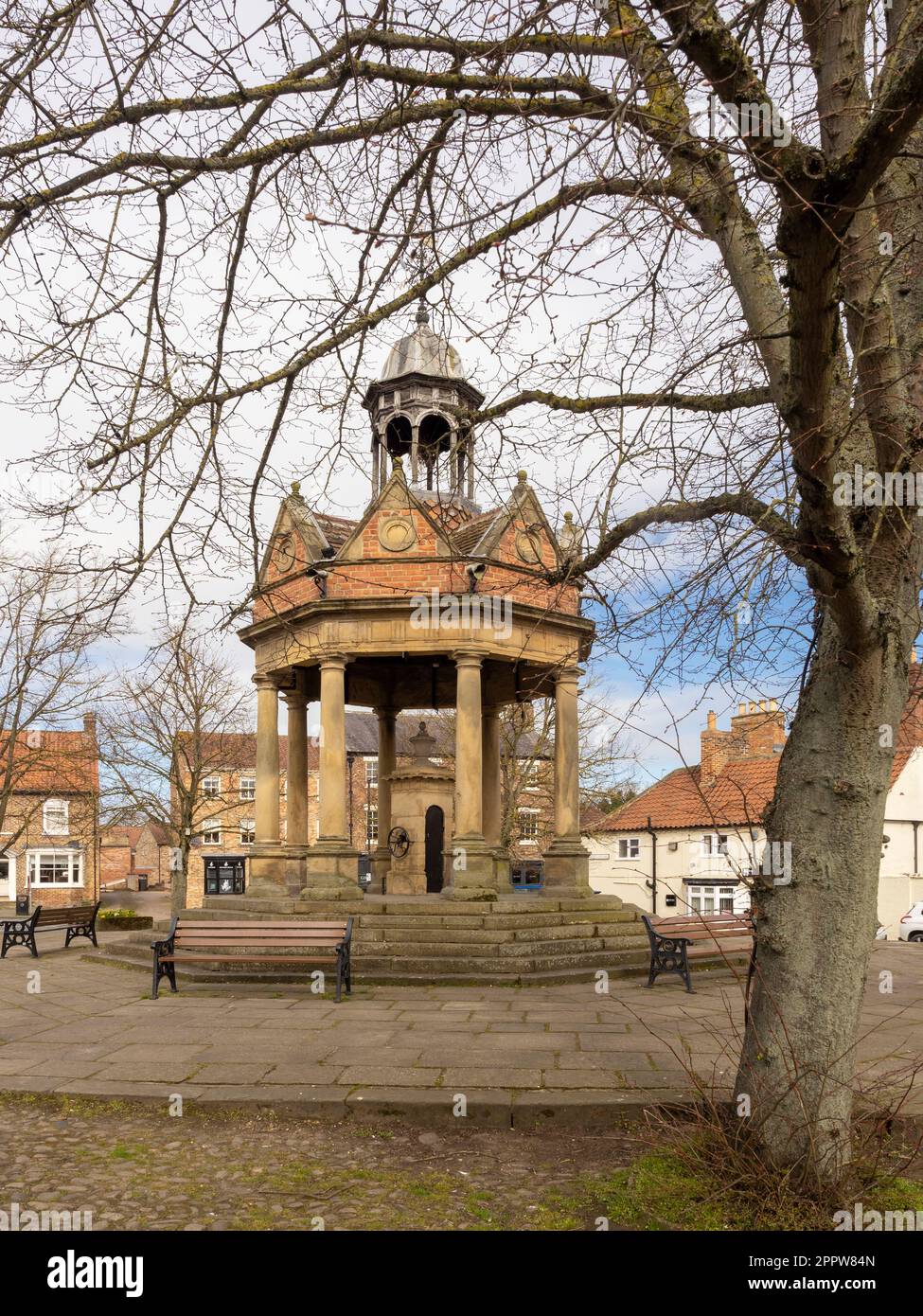 Market Well, grade II listed water well situated in St James Square in Boroughbridge, North Yorkshire, UK Stock Photo