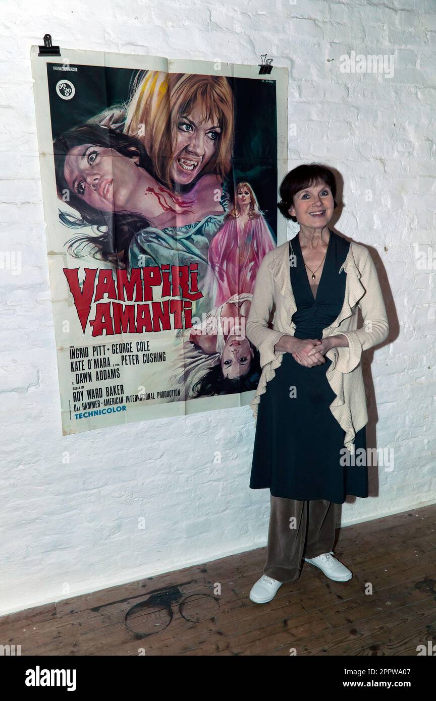 Madeline Smith posing by a poster of 'The Vampire Lovers', during an evening devoted to he acting career, hosted by the Misty Moon Film Society. Stock Photo