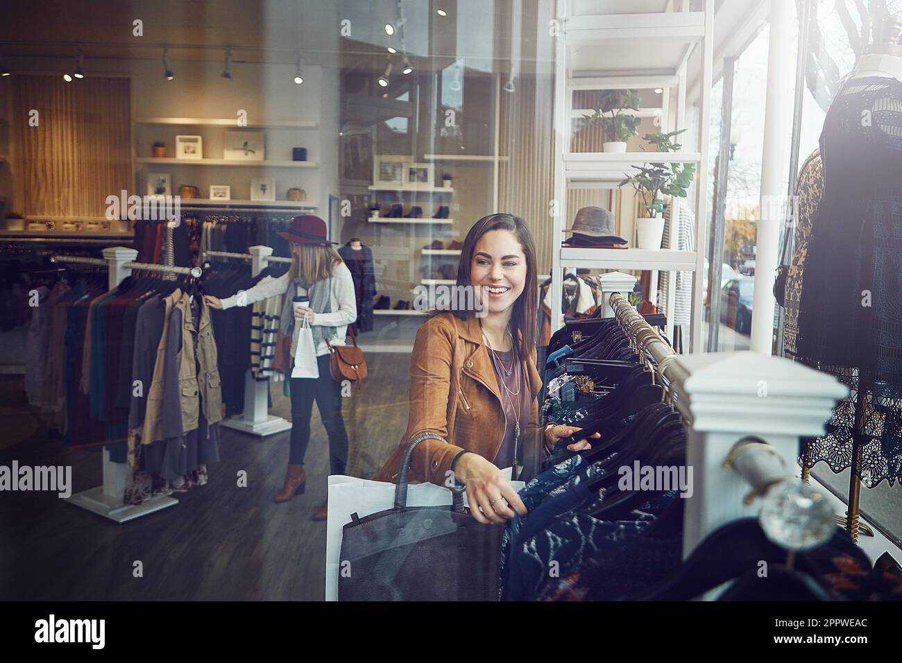 Shopping is the only sport I need. a young woman shopping at a clothing