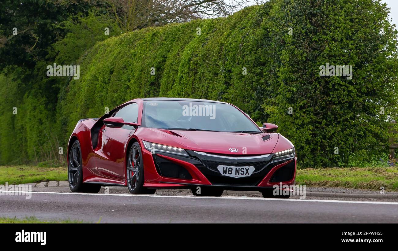 Bicester,Oxon,UK - April 23rd 2023. 2018 red Honda NSX hybrid electric car travelling on an English country road Stock Photo