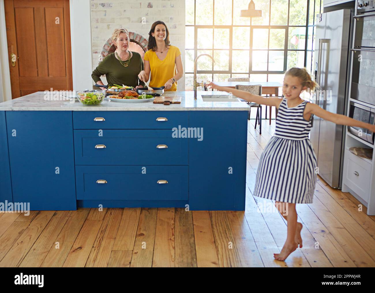 Good food makes for a happy family. a little girl dancing while her