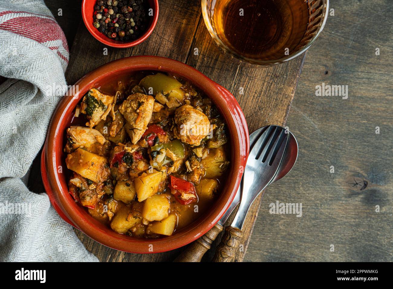 Chicken stew with vegetables and a glass of orange wine Stock Photo Alamy