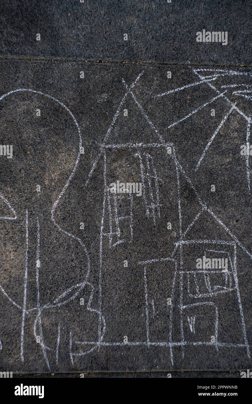 Overhead view of a child's chalk drawing on tarmac Stock Photo