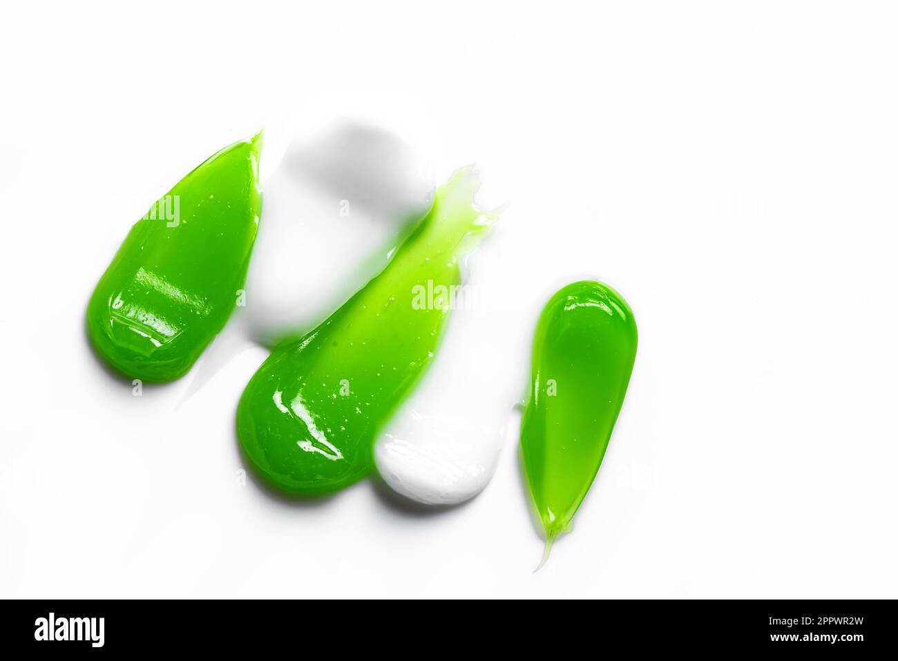 Green and white gel samples isolated on white background, close up
