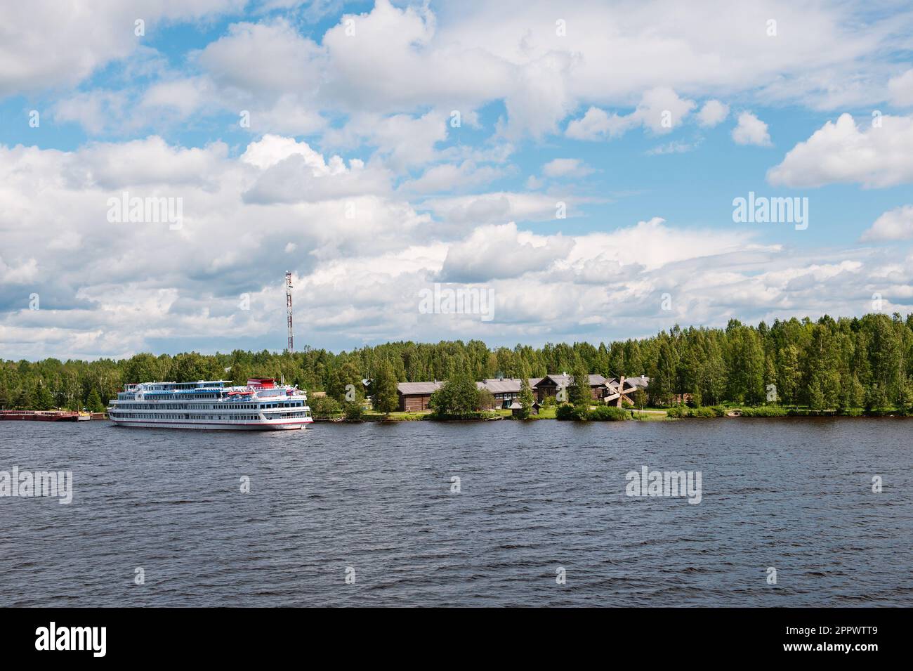 MANDROGI, RUSSIA - JUNE 8, 2015: Karelia region, old wooden houses on the banks of the Svir River. Restored ancient village, the berth of tourist ship Stock Photo