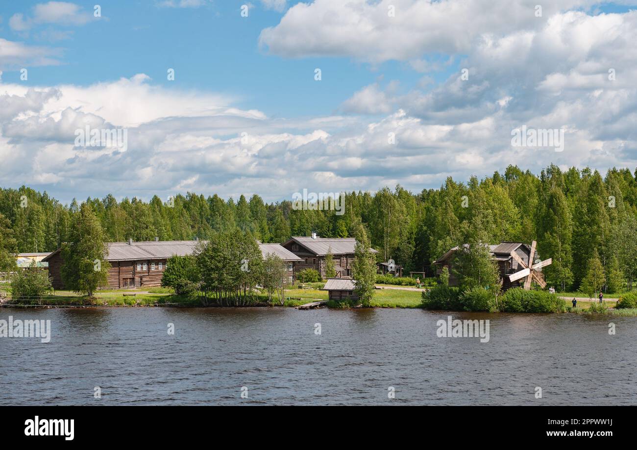 MANDROGI, RUSSIA - JUNE 8, 2015: Karelia region, old wooden houses on the banks of the Svir River. Restored ancient village, the berth of tourist ship Stock Photo