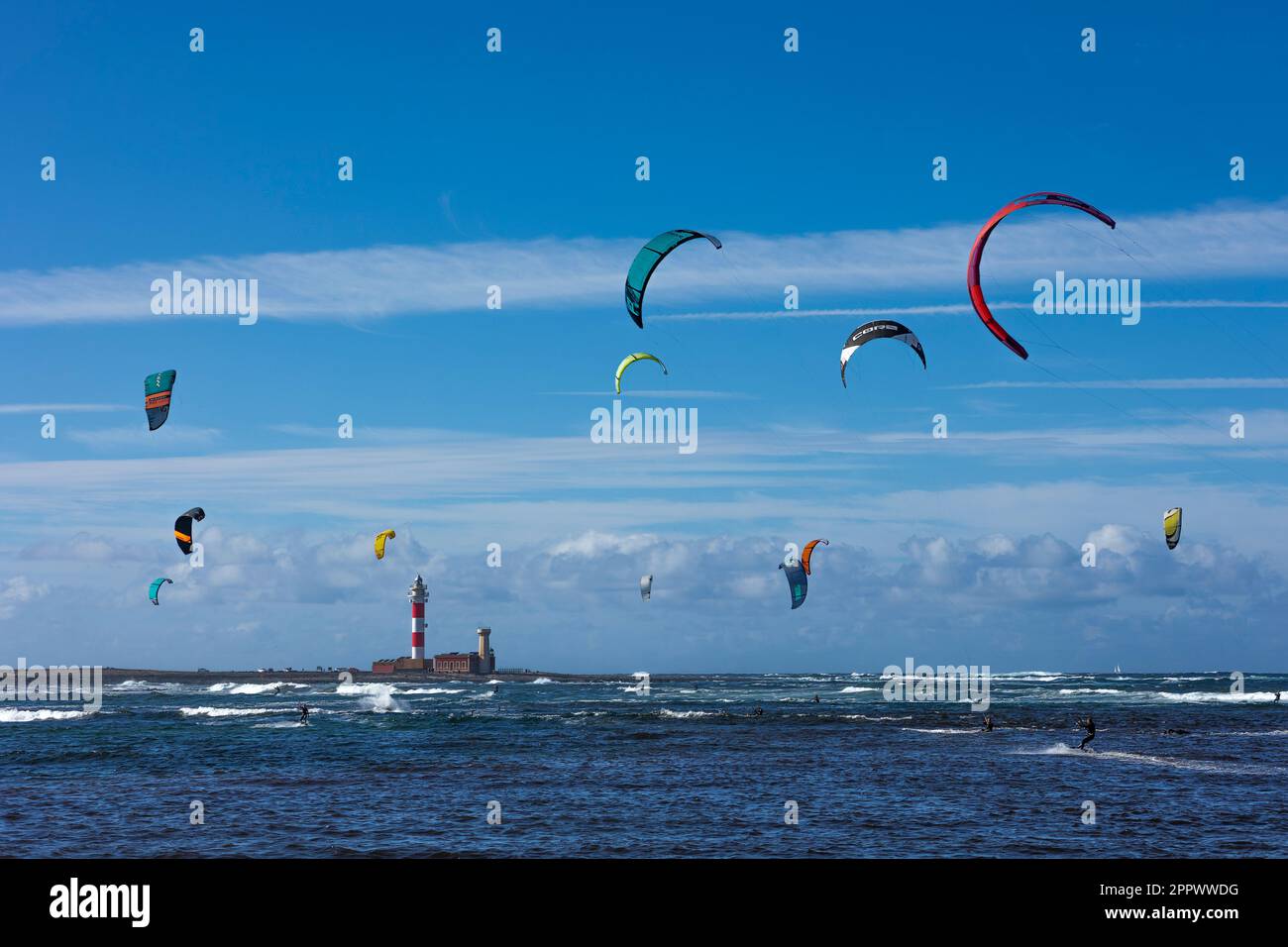 Kite surfing at El Cotillo Fuerteventura with El Toston Lighthouse in the background Stock Photo
