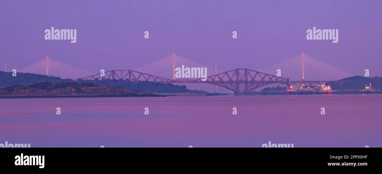View of Forth bridges at sunrise: Queensferry crossing, Forth Road Bridge and Forth Rail Bridge, Firth of Forth, Scotland, UK Stock Photo