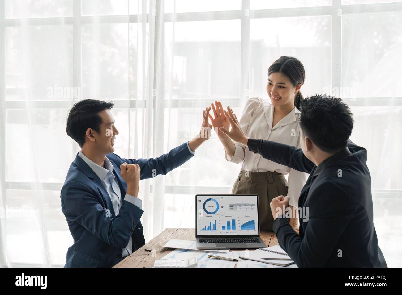 business people at desk boardroom celebrating success giving high five ...
