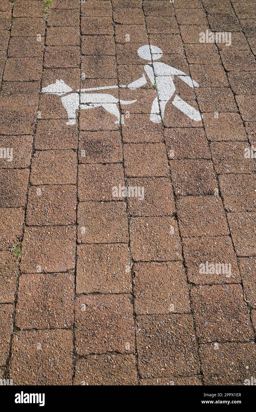 Sign to keep dogs on a lead or leash, painted on the footpath Stock Photo