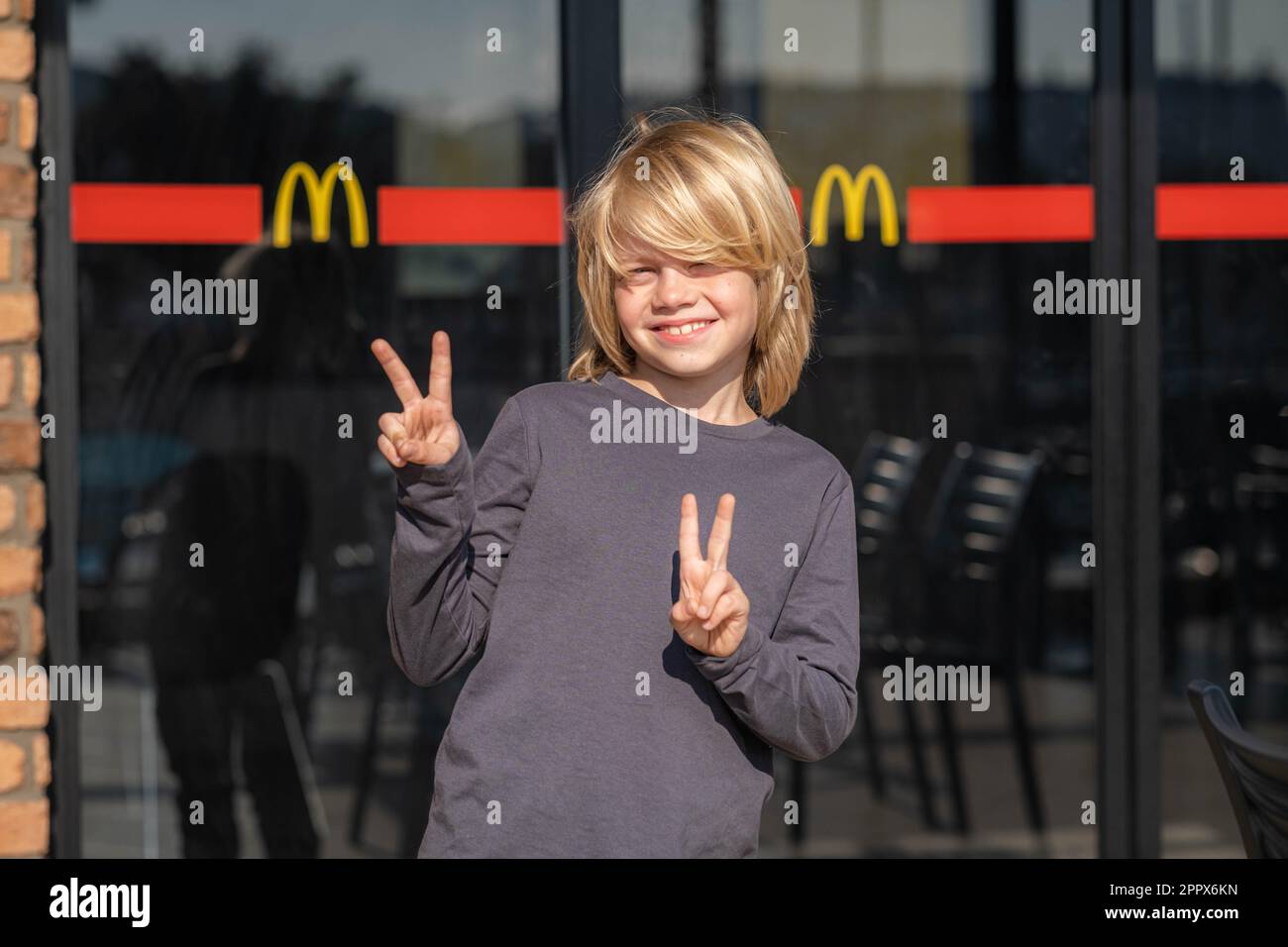 Portrait Happy Blonde Boy Near Doors Logo McDonalds Fast Food portrait-happy-blonde-boy-near-doors-logo-mcdonalds-fast-food