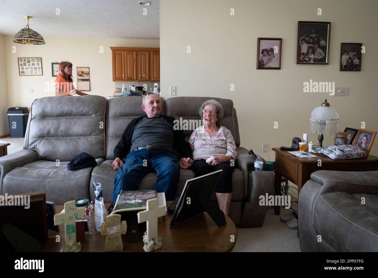 Kristina Ferguson, top left, walks near Norma Carr and Robert Carr at the  home they are temporary staying at in Columbiana, Ohio, Wednesday, April 5,  2023. The family was displaced by the