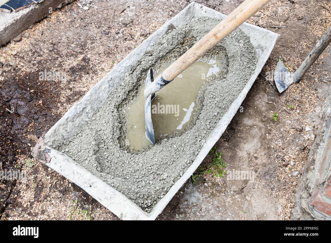 cement, sand and gravel mix in bath for making concrete in backyard in
