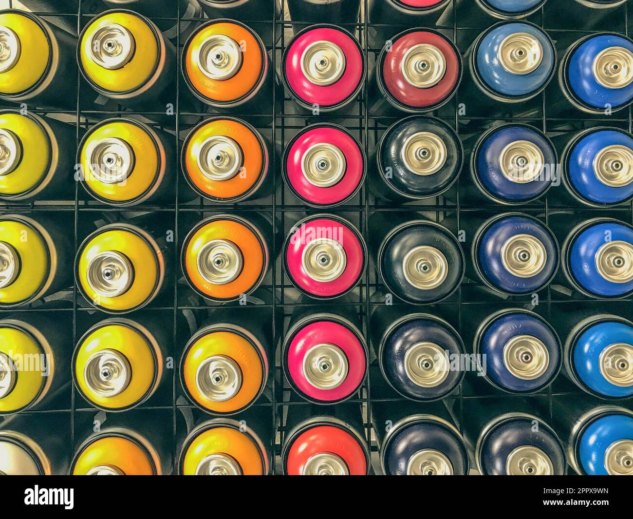 spray cans of paint are on display. paint sprayers of various colors