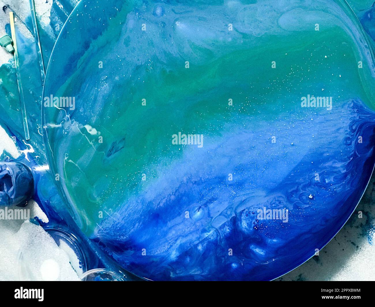 The process of creating a home-made trendy abstract modern pattern painted  with acrylic resin. Woman artist in home studio. Epoxy resin Stock Photo -  Alamy