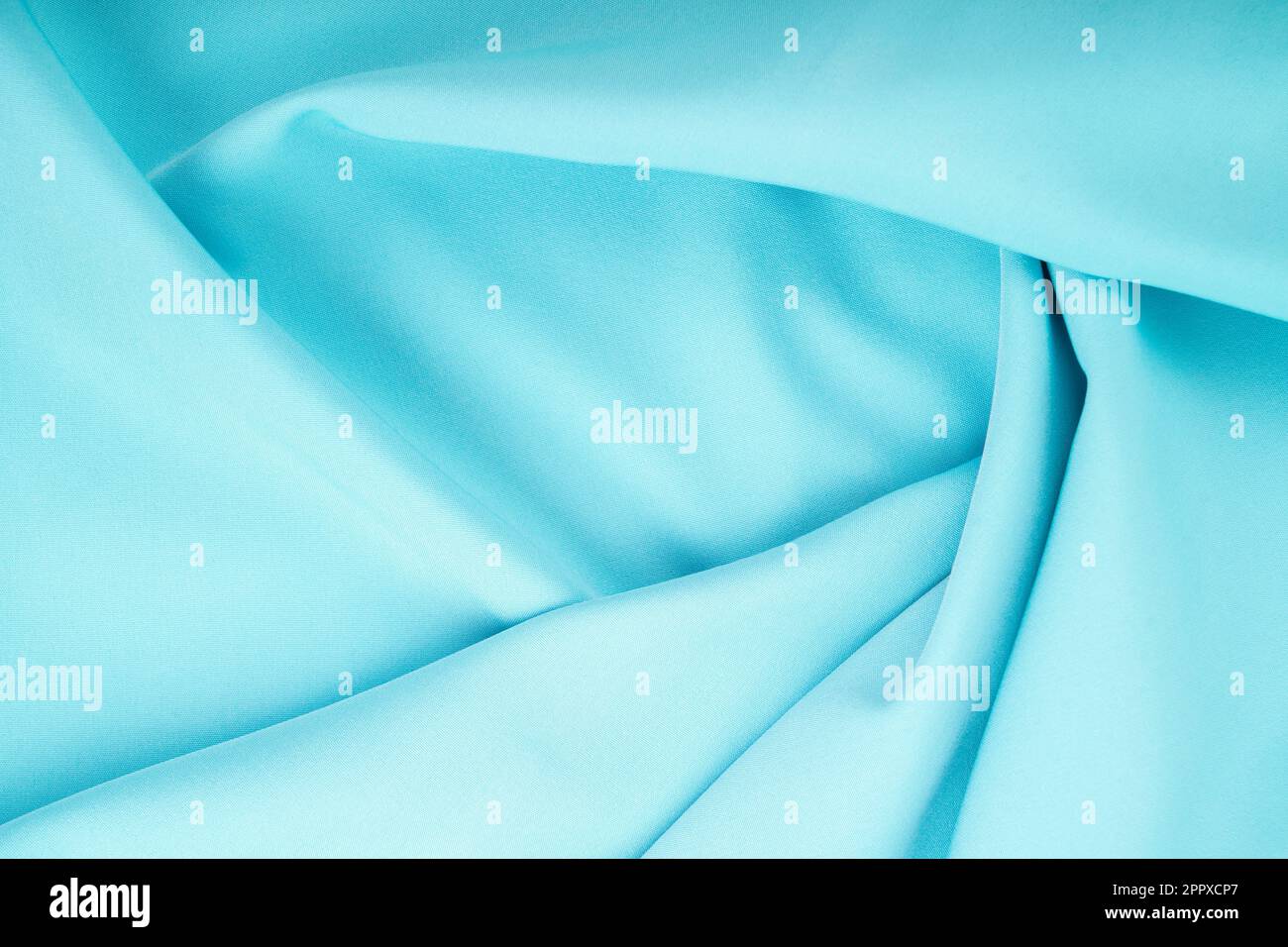 Twisted turquoise satin texture as background. Stock Photo