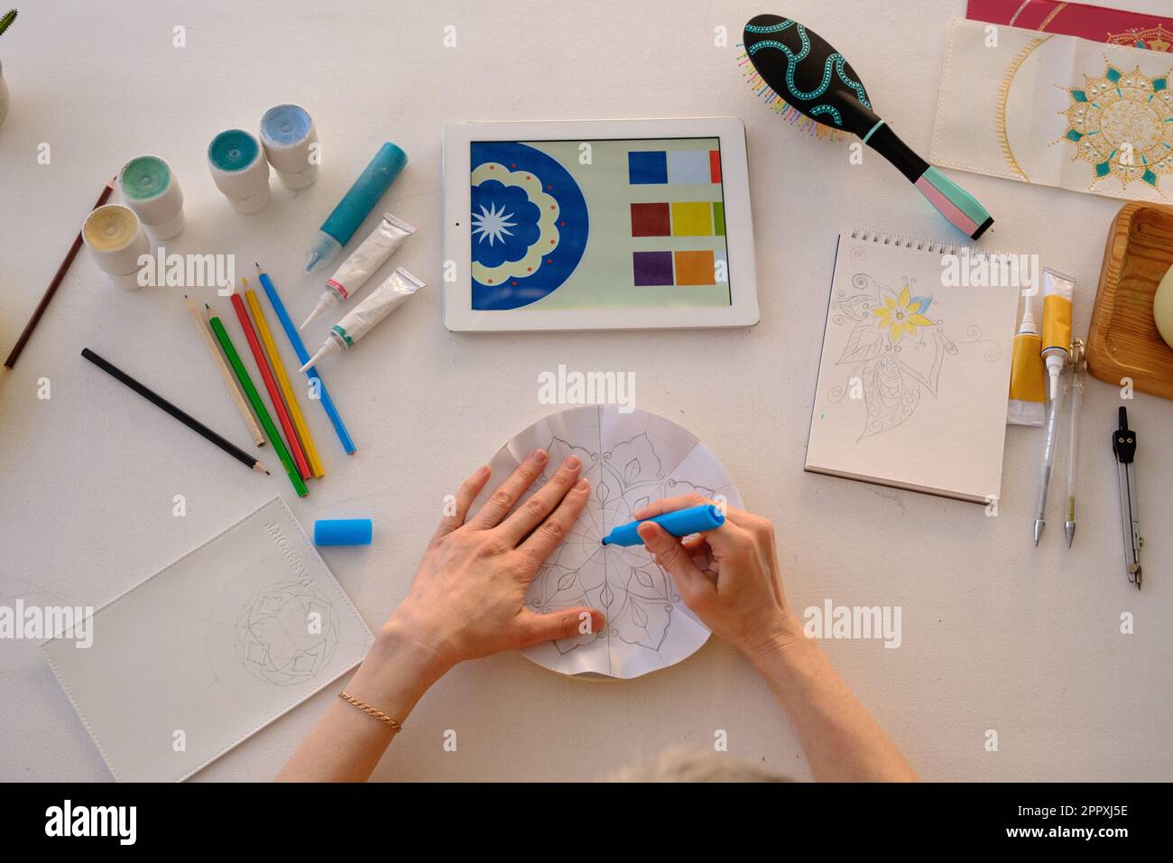 Top view of crop anonymous artist drawing with colorful paints on ...