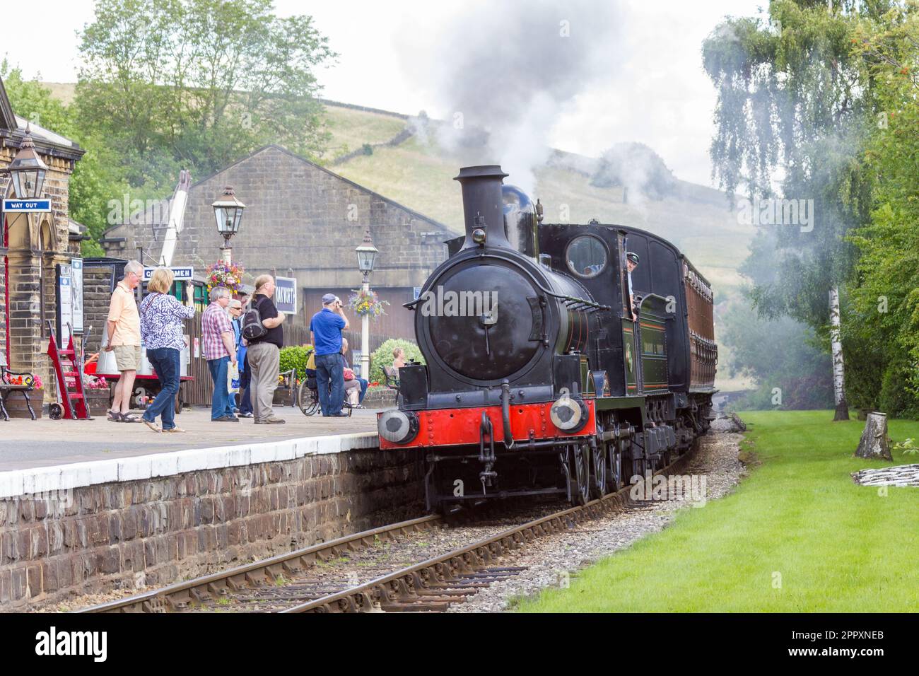 A Steam passenger train arriving at Oakworth on the Keighley & Worth Valley Railway (KWvR) Stock Photo