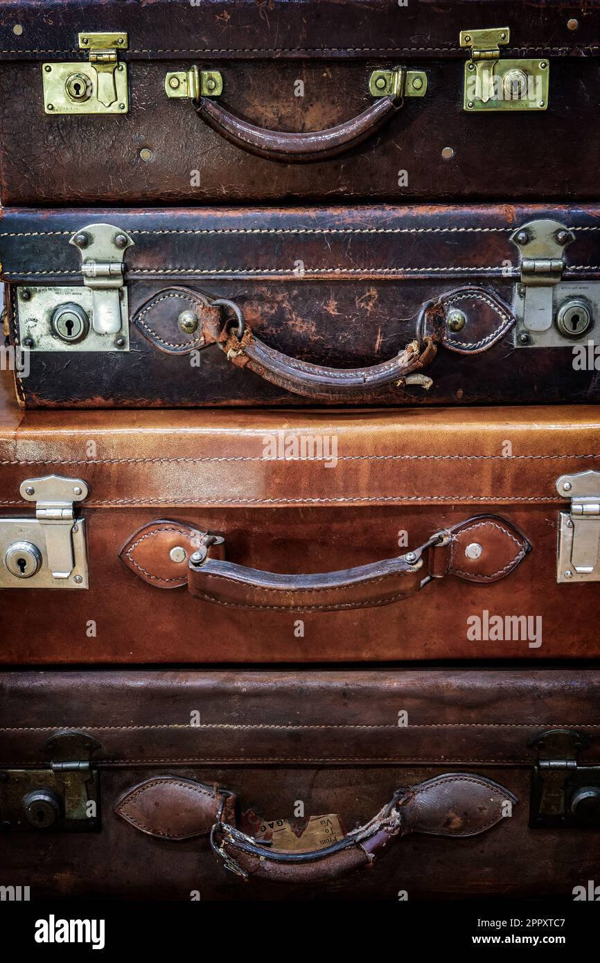 Pile of old antique leather suitcases, travel background Stock Photo