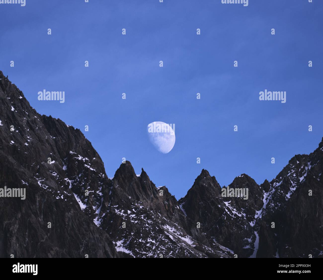 Waxing Gibbous Moon rising over Caucasus mountains in Kazbegi
