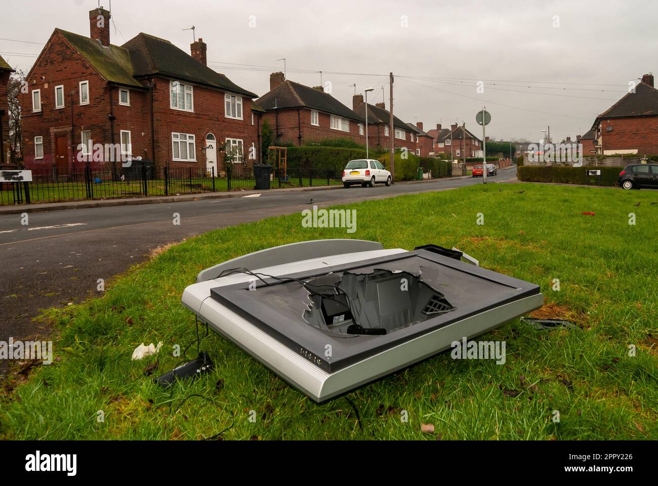 broken television set illegally dumped in the middle of a housing estate Stock Photo