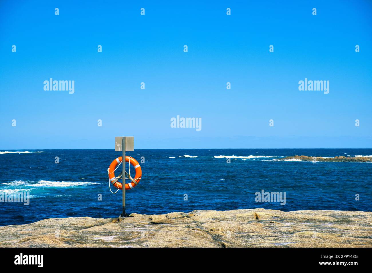 Lifebuoy on a rock by the sea. William Bay National Park, Western Australia. Stock Photo