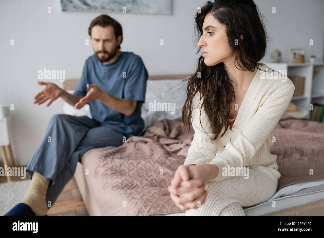 Sad woman sitting clenched hi-res stock photography and images - Alamy