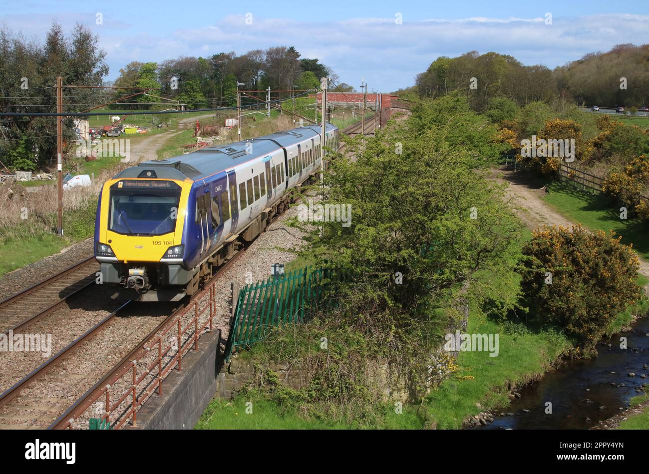 Northern Trains Civity class 195 dmu 195104 Deva Victrix West Coast Main Line in countryside at Woodacre near Garstang, Lancashire, 25th April 2023. Stock Photo