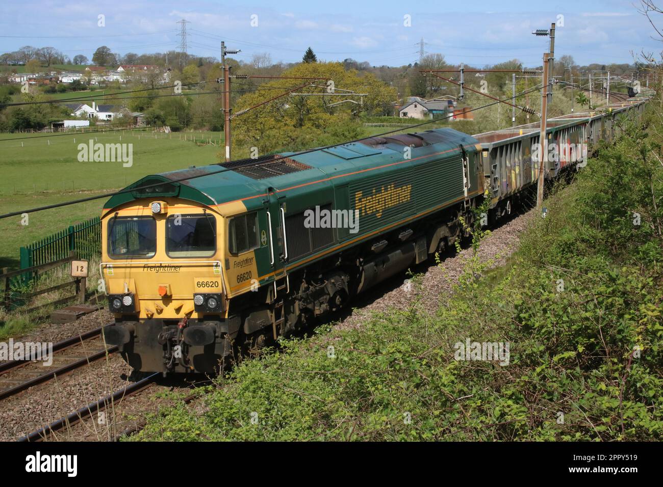 Freightliner class 66 loco, 66620, on the West Coast Main Line with aggregates freight train near Scorton in Lancashire on 25th April 2023. Stock Photo