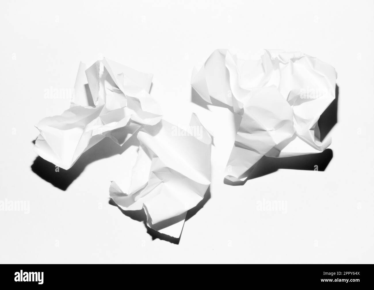 three crumpled balls of white paper on white background Stock Photo