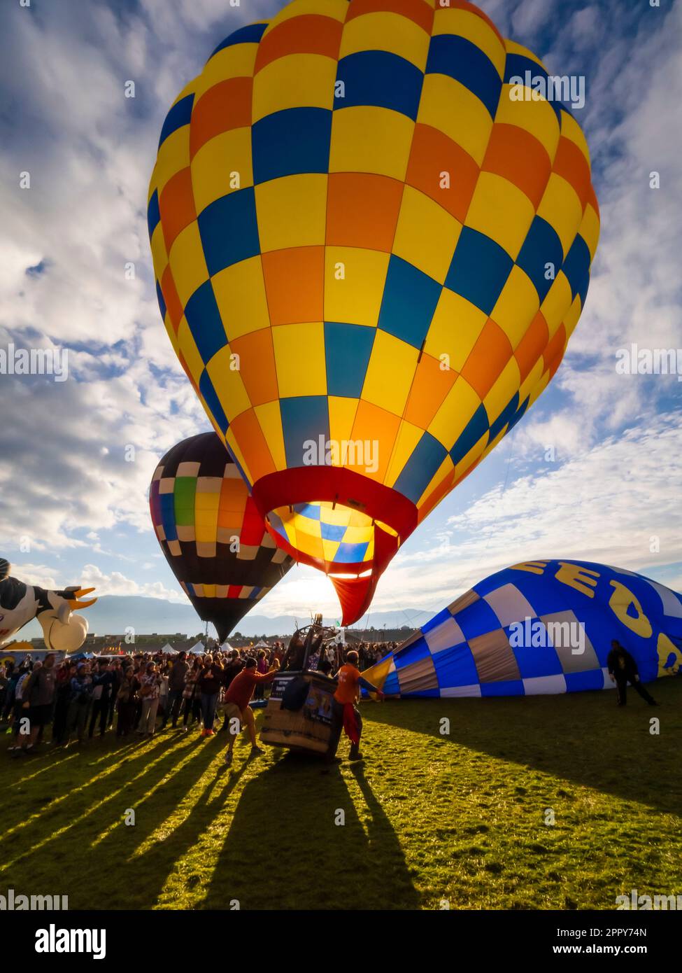 Ground level view of a hot air balloon lifting off at Sunrise