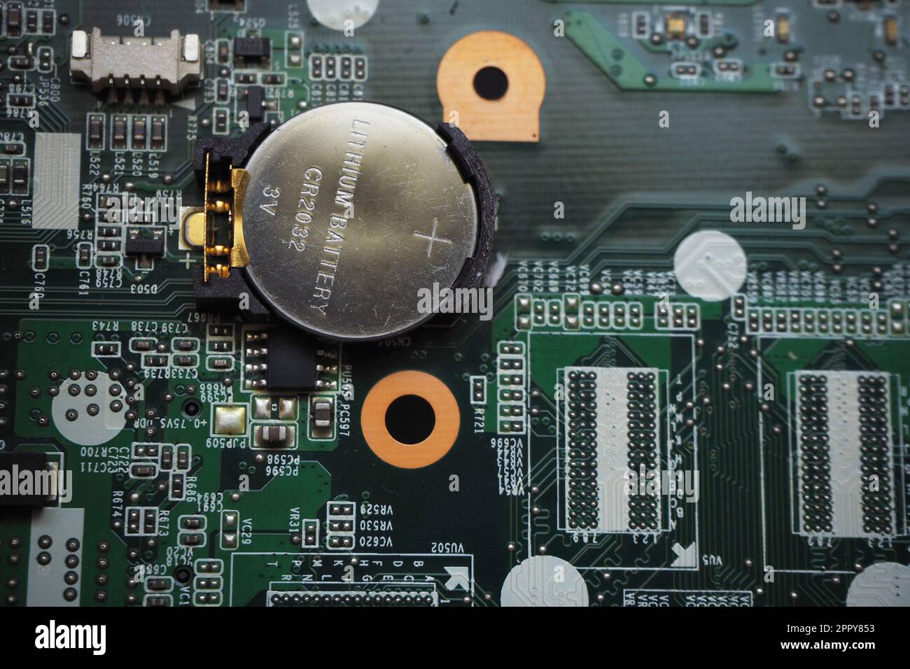 3 Volt lithium battery on the motherboard to feed the configuration memory and real time clock of the device. Battery-backed electronic cards. Focused Stock Photo