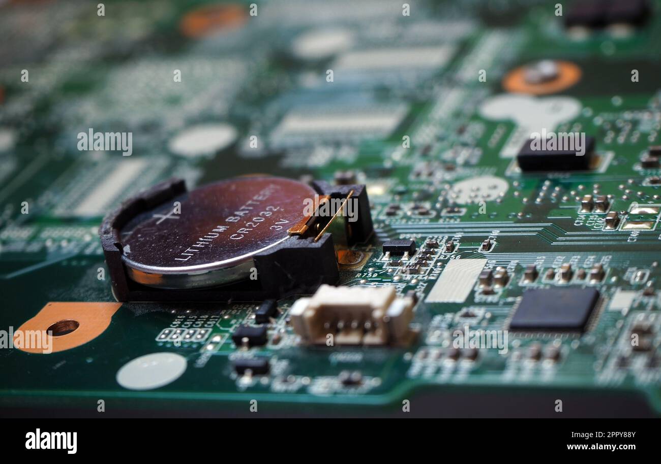 3 Volt lithium battery on the motherboard to feed the configuration memory and real time clock of the device. Battery-backed electronic cards. Focused Stock Photo