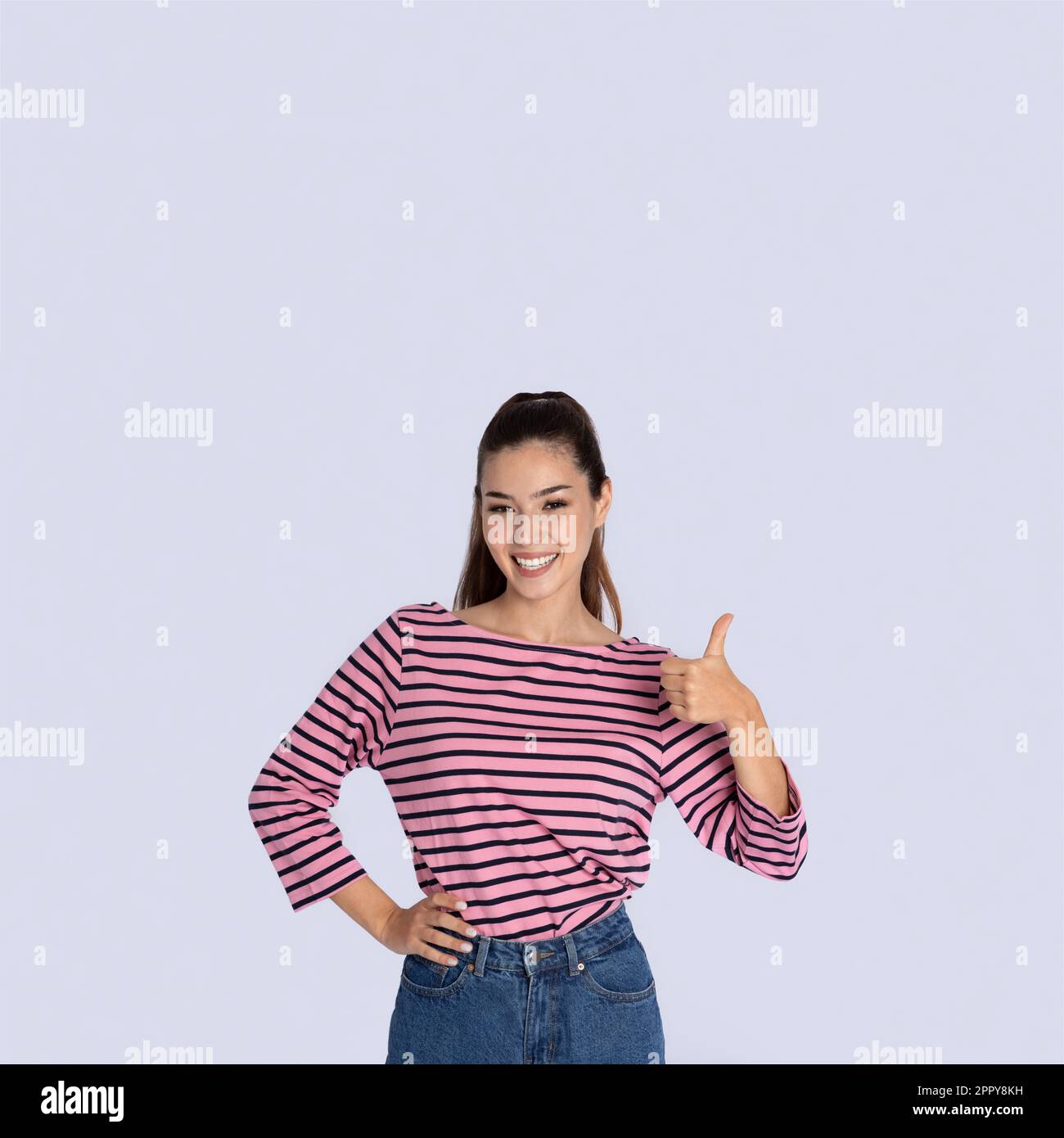Happy pretty hispanic young woman showing thumb up gesture Stock Photo ...