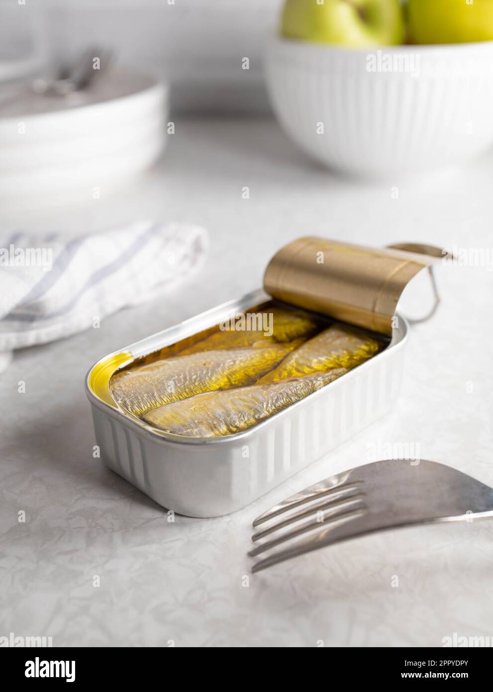 Canned sardines on kitchen table Stock Photo