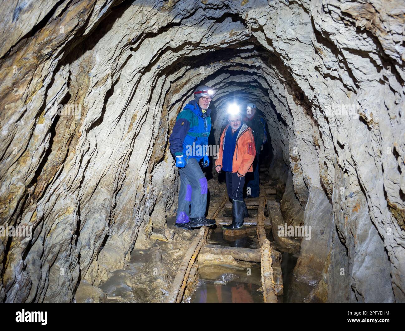 Men exploring an old abandoned copper mine in Tilberthwaite, Lake District, UK. Stock Photo