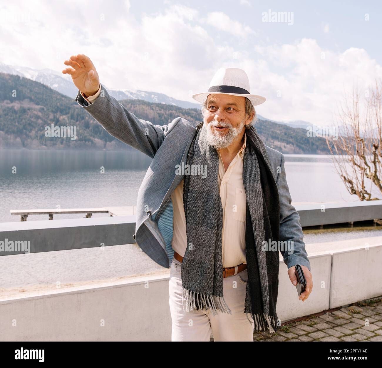 Portrait of a confident, handsome, mature man, pensioner, grandfather in the small town Stock Photo