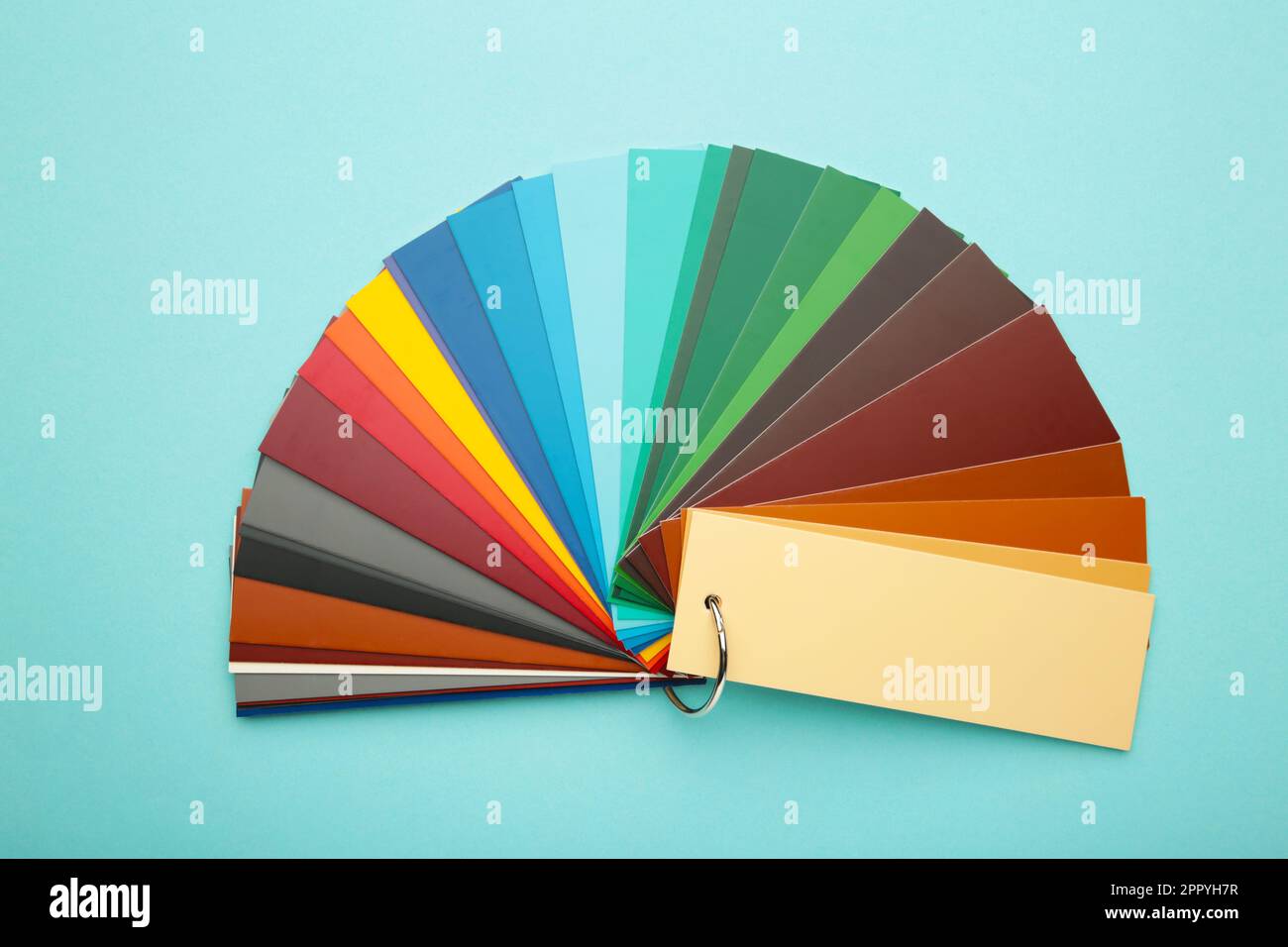 Colored cardboard palette, paper catalog on a blue background. Top view
