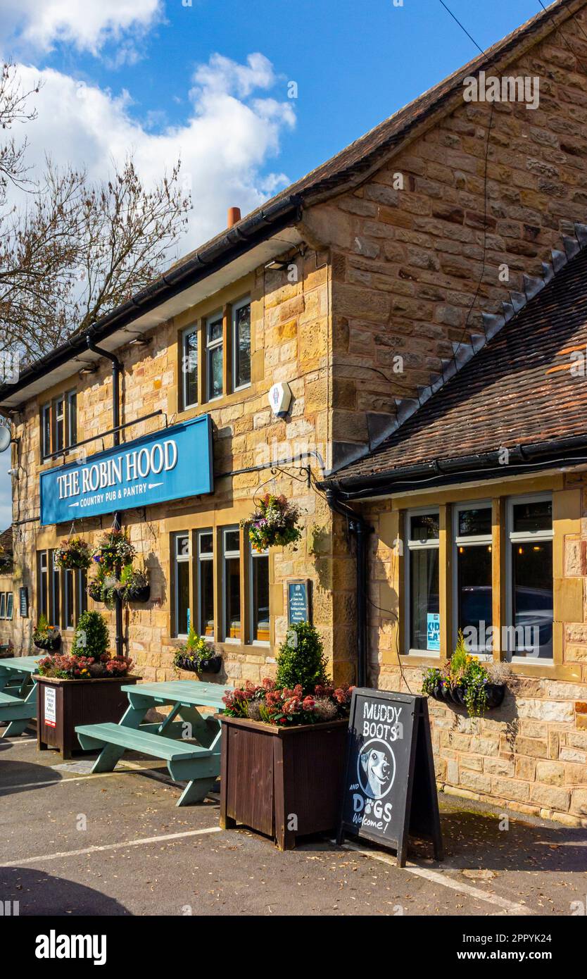 Exterior view of the Robin Hood a country pub near Baslow in the Derbyshire Peak District England UK with Muddy Boots and Dogs Welcome sign outside. Stock Photo