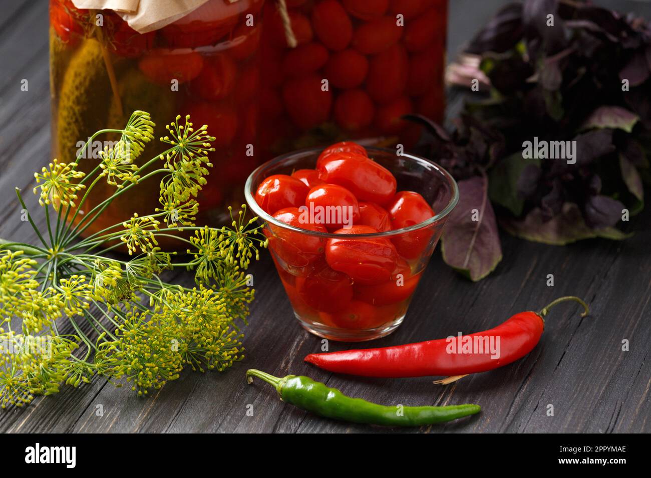 Pickled cherry tomatoes in a bowl garlic red and green chili