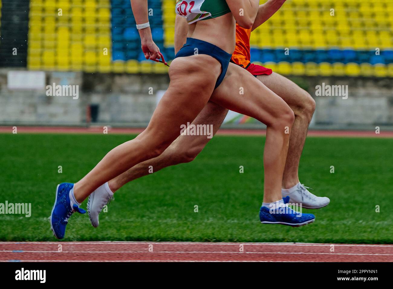 unseeing female runner running together with guide sprint at stadium, summer competition blind runners Stock Photo