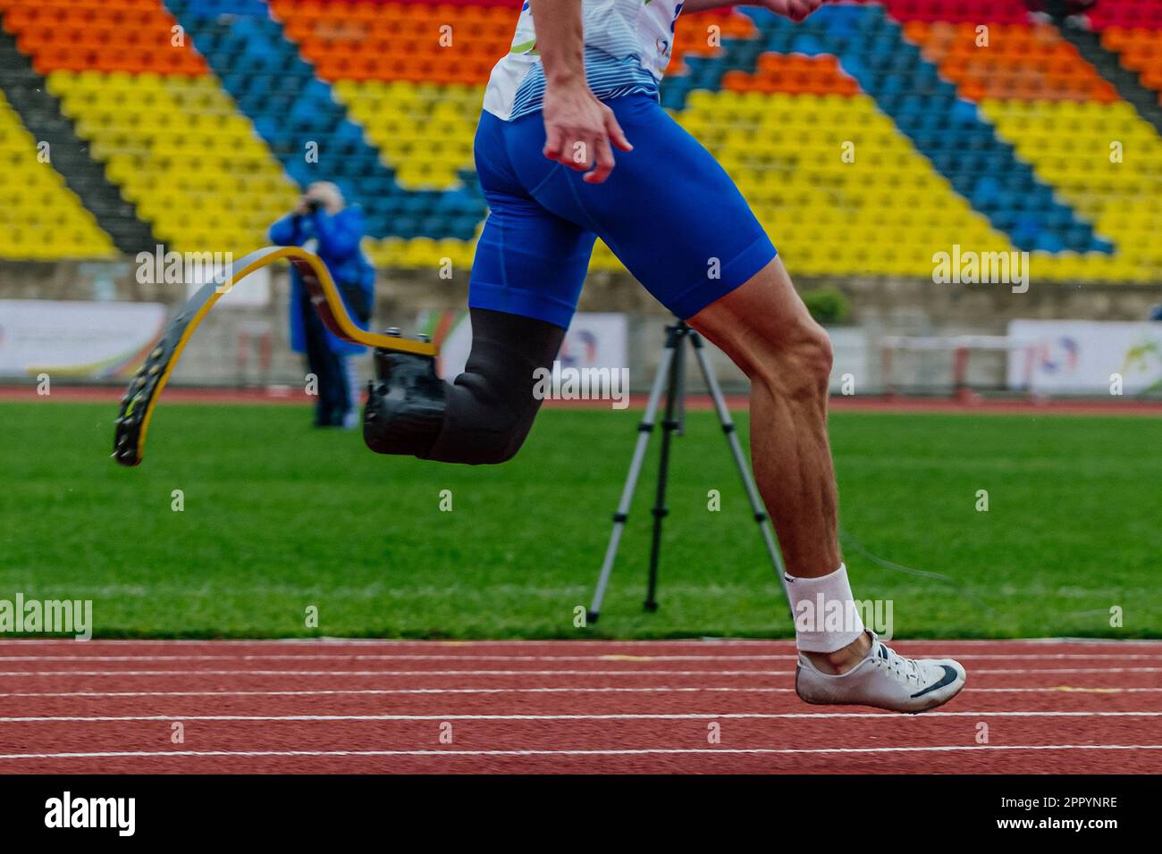 male runner para-athlete on Nike prosthesis and spikes shoes running track stadium, summer para athletics championships Stock Photo