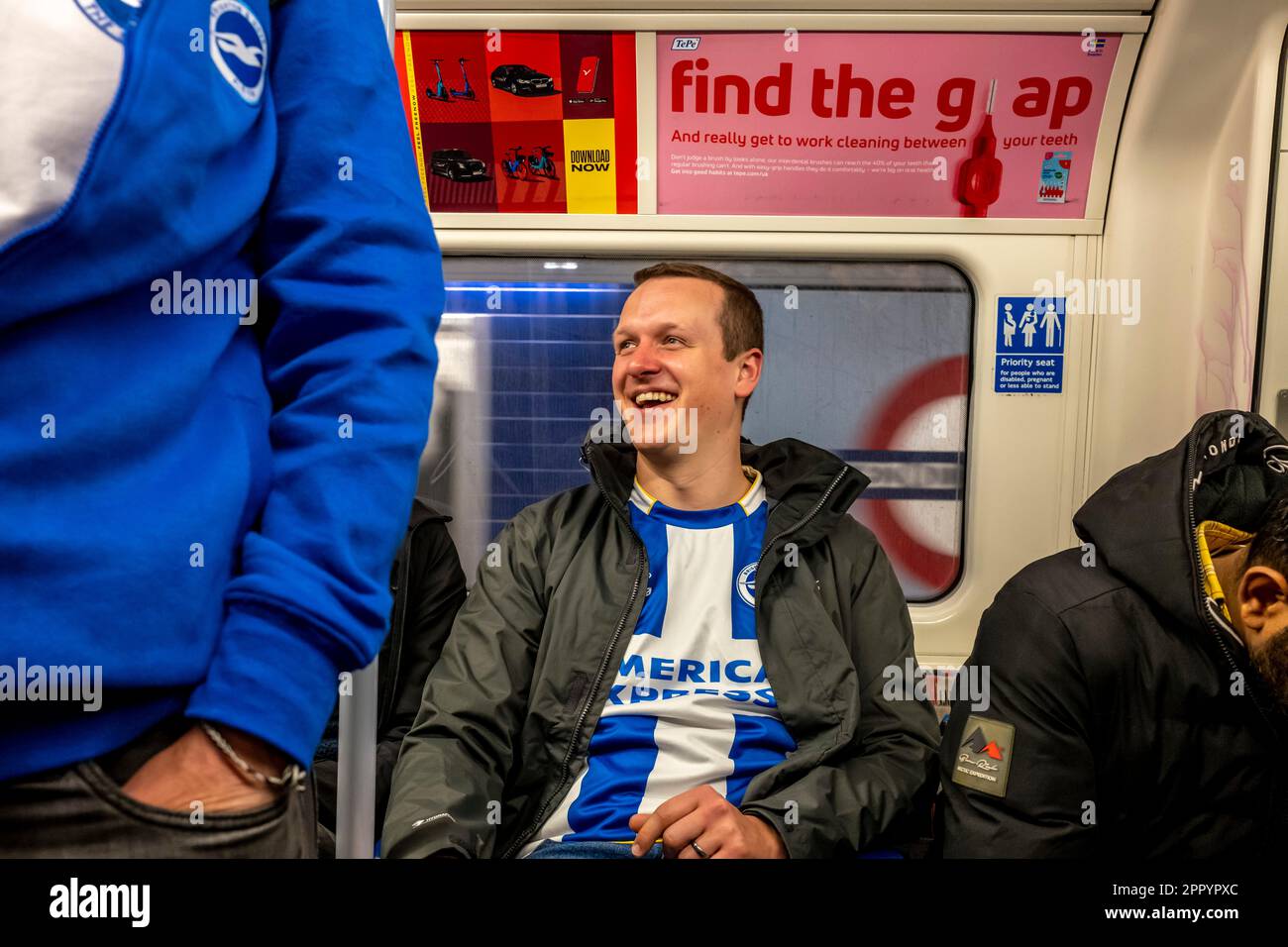 Brighton and Hove Albion Football Fans Travel On The London Underground On Their Way To Watch The 2023 FA Cup Semi Final, London, UK. Stock Photo