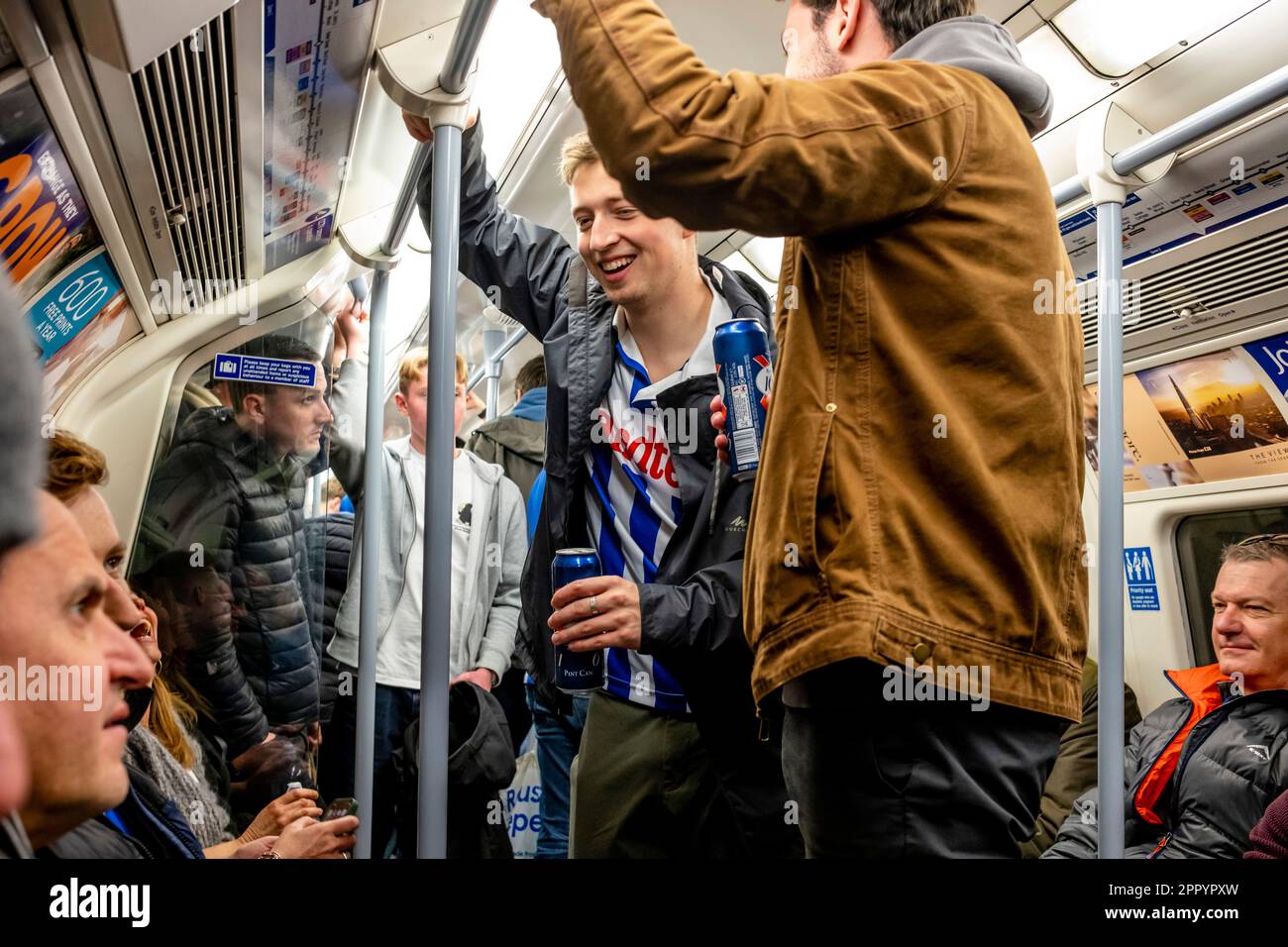 Brighton and Hove Albion Football Fans Travel On The London Underground On Their Way To Watch The 2023 FA Cup Semi Final, London, UK. Stock Photo