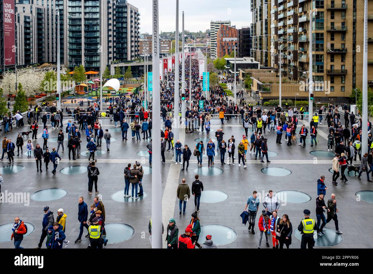 Football Fans Of Brighton and Hove Albion and Manchester United Walk Along Olympic Way To Wembley Stadium To Watch The 2023 FA Cup Semi Final, London. Stock Photo