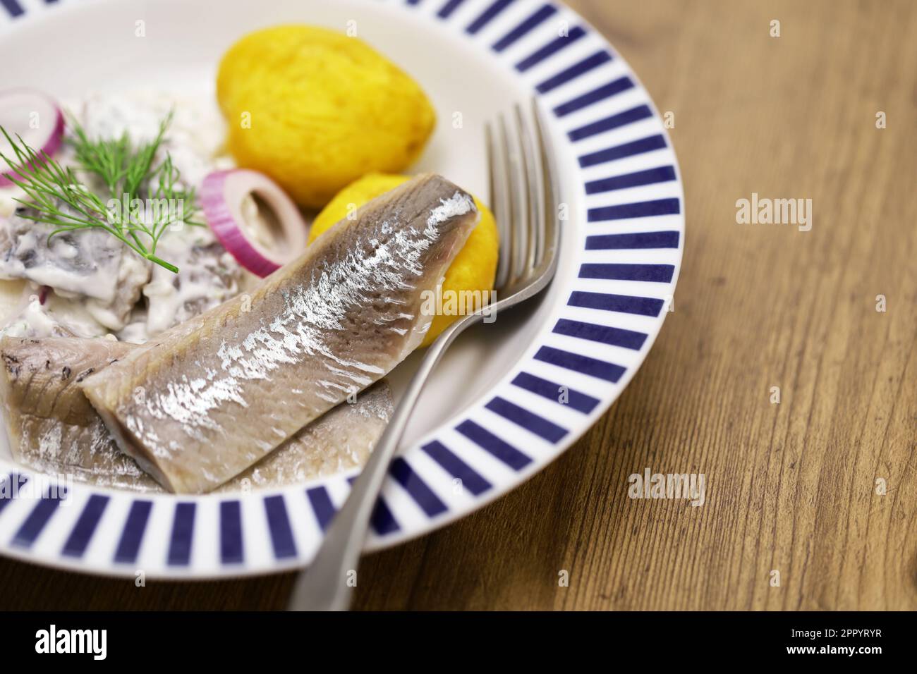 pickled young herring fillet ( matjes ) with boiled potato Stock Photo