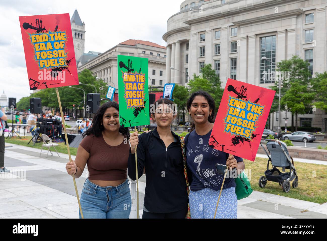 The three young women holding End the Era of Fossil Fuels signs at the ...