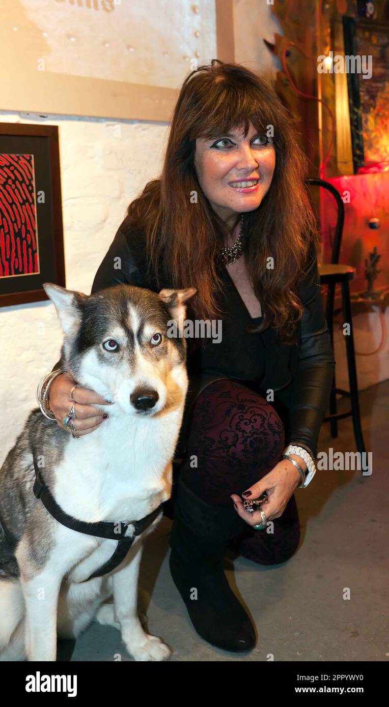 The actress Caroline Munro, posing with Luna the Husky, at an event hosted by the Misty Moon Film Society's, at the Ladywell Tavern, Lewisham. Stock Photo
