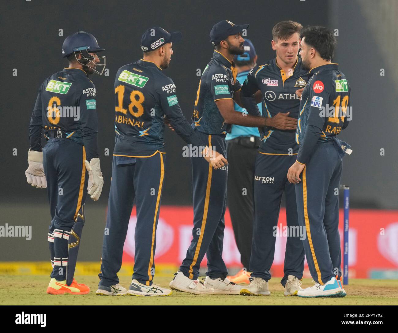 Gujarat Titan's Noor Ahmad, second left, celebrates with teammates the